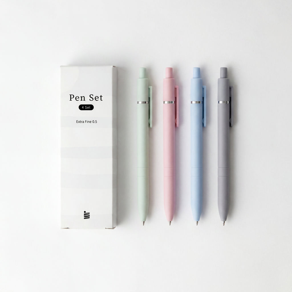 A box labeled "Extra Fine Ball Point Pen Set" by Eterna Goods sits next to four extra fine pens in pastel green, pink, blue, and gray—ideal for precise writing—arranged on a white background.