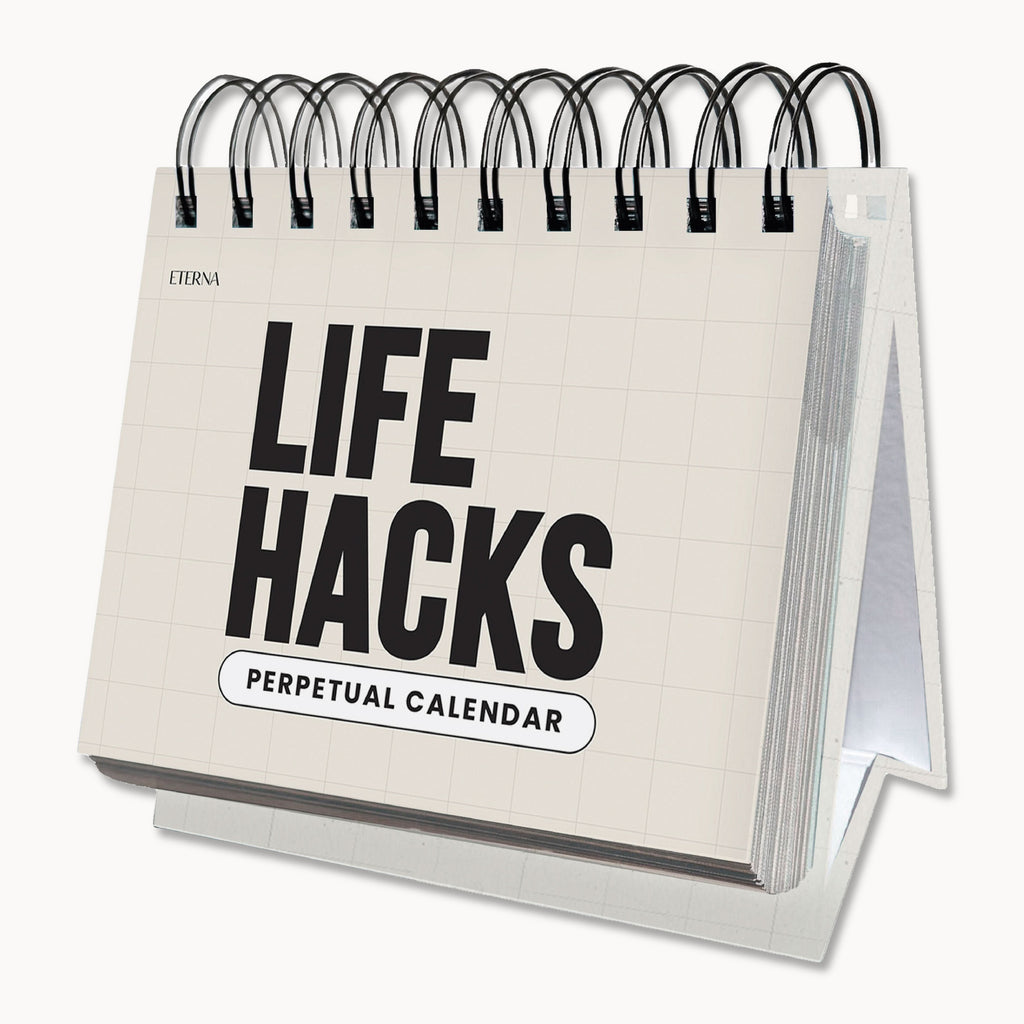 The Perpetual Life Hacks Calendar by Eterna Goods is a spiral-bound desktop calendar featuring a white cover with black text, packed with daily productivity tips to help you make the most of every day.