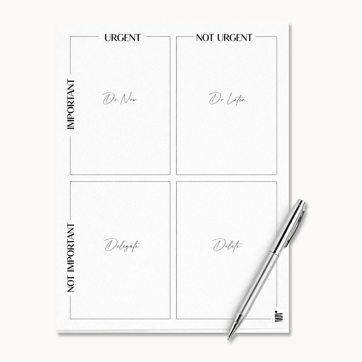 The Eisenhower Matrix - Printable File by Eterna Goods features four labeled quadrants and comes with a pen on the page, making it ideal for effective decision-making.
